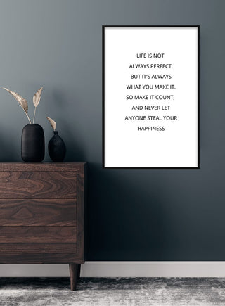 Minimalist "Make it count" poster with motivational quote, framed on a dark wall above a wooden dresser.