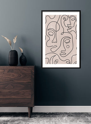 Framed line art faces kunstposter featuring abstract faces, displayed above a dark wood dresser in a modern room.