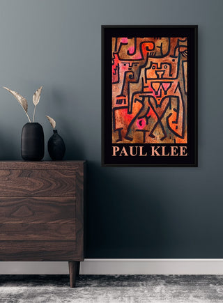 Framed Paul Klee Exhibition poster featuring abstract geometric artwork, displayed on a dark wall above a dresser.