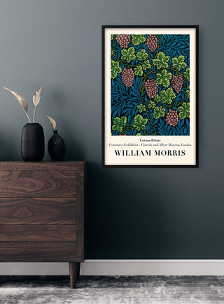 Framed Vintage Grapes - Morris Plakat art print displayed on a dark wall above a wooden dresser.