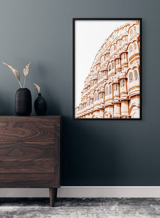 Framed Indian wall art featuring ornate historic architecture, displayed above a wooden dresser in a modern room.
