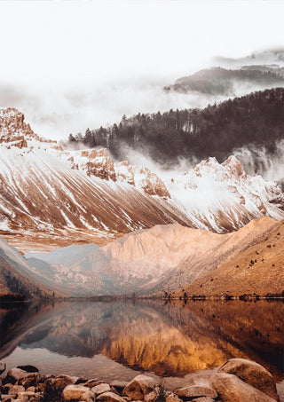 Poster of a tranquil lake reflecting snow-capped mountains and misty forest in warm, natural tones.