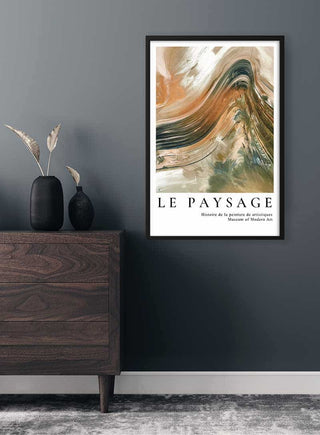 Framed abstract painting poster "Le Paysage" displayed on a dark wall above a wooden dresser.