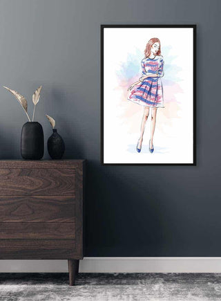 Framed Blue Dress Girl Plakat displayed on a dark wall above a wooden dresser with minimalist decor.