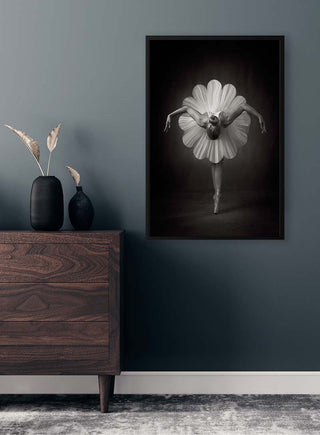 Framed Floral Ballet Catchlight Studio Plakat on a dark wall above a wooden dresser with decorative vases.