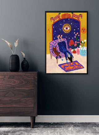 Art print "Day off from office" by Jotadejai on a dark wall above a wooden dresser with vases and dried plants.