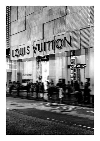 Black and white photo of a Louis Vuitton storefront with people walking outside.