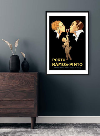 Framed Ramos-Pinto Vintage Plakat poster with two men and a child sharing a glass, displayed on a modern wall.