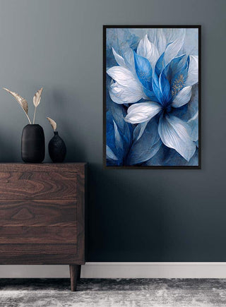 Framed print of "Blå Blomst 2" by Winnie Møller featuring a blue and white flower, displayed above a dresser.