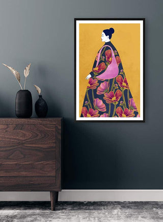 Framed "I Think" by Elara Monet, featuring a floral-robed woman on a gold background, hung above a dresser.