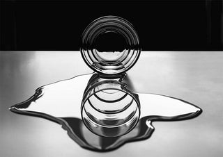 Glass circle with concentric rings reflecting on a liquid surface, artwork from Circles of circles by Giorgio Toniolo.