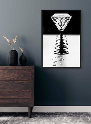 Framed Giorgio Toniolo Goblets artwork displayed above a wooden dresser in a modern, stylish room.