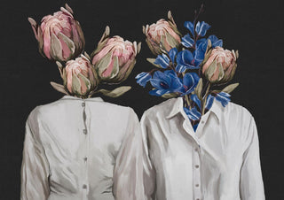Two white shirts with flowers instead of heads, one with pink proteas, one with blue flowers, on black background.