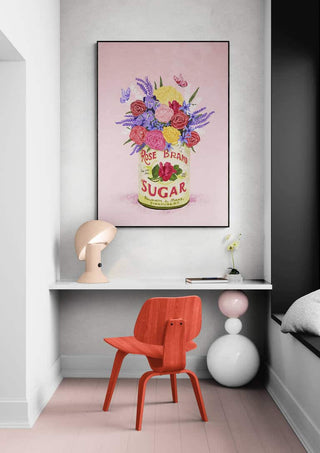 Framed artwork "Flowers In a Vintage Can" by Raissa Oltmanns displayed above a modern desk and red chair.