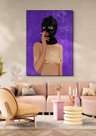 Poster of a topless figure in a black mask smoking, with a purple background, on display above a modern sofa.