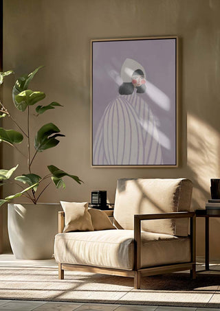 Framed print of "The Woman With the White Hat" by Bea Muller hanging above a beige armchair in a modern room.