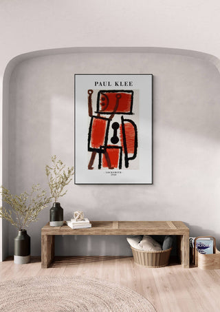 Framed "Locksmith 1940" art print by Paul Klee on a light gray wall above a wooden bench in a modern room.