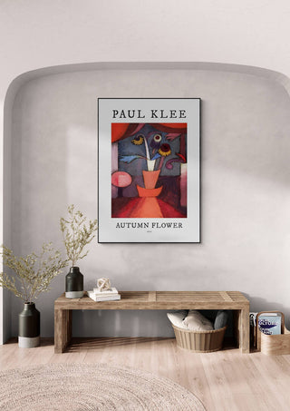 Framed print of Paul Klee's "Autumn Flower 1922" hanging above a wooden bench in a modern room.