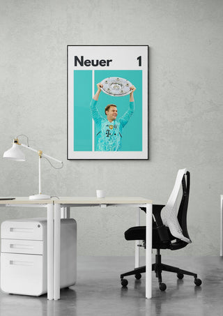 Manuel Neuer football poster featuring him holding a trophy, displayed on a modern office wall.