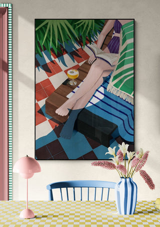 Art print of a person reading by the pool, with blue towel, palm leaves, and summer sunlight for home decor.