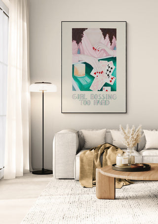 Modern living room featuring "Girl Boss - Christine Buchholtz" artwork above a sofa and wooden coffee table.