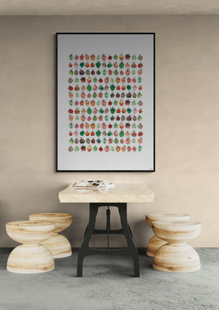 Colorful apple print by Hedwig Wallin displayed above a wooden table and stools in a modern interior setting.