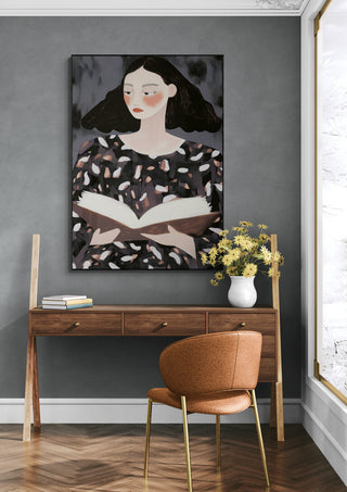 The Reader by David Wolf artwork hanging above a wooden desk in a stylish, modern room.