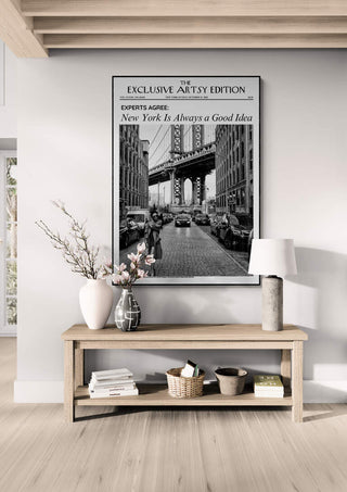 Framed New York Always Artsy Edition print displayed above a wooden console table with decor in a modern room.