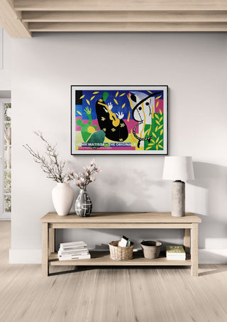 Framed "Sorrow of The King 1952" by Henri Matisse displayed above a wooden console in a modern living room.