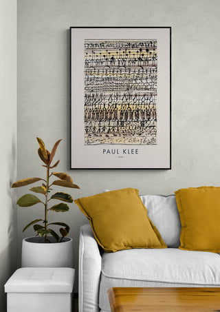 Framed "Cooling in a hot zone garden 1924 - Paul Klee" print hanging above a sofa with yellow cushions.
