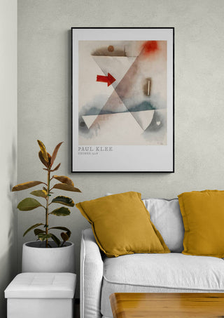 Framed print of Chimes 1928 by Paul Klee hanging above a white sofa with mustard pillows in a modern living room.