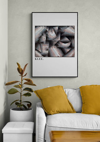 Framed "Dry Cooler Garden 1921" by Paul Klee hanging above a sofa with yellow cushions in a modern living room.