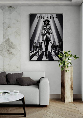 Framed “Stripes by Prada” artwork displayed in a modern living room above a white sofa and next to a plant.