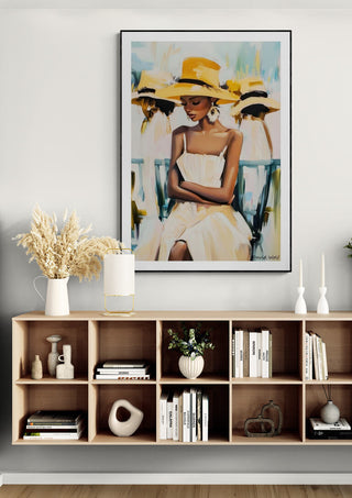 Framed Lady - David Wolf artwork featuring a woman in a yellow hat displayed above a modern console shelf.