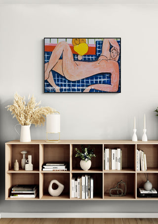 Pink Nude 1935 by Henri Matisse displayed above a modern bookshelf in a stylish living room setting.