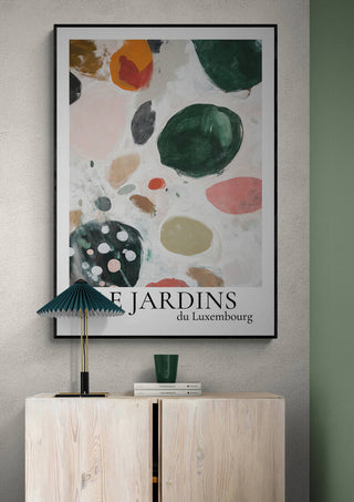Abstract art print titled "Le Jardin Du Luxembourg 02" displayed above a modern wooden cabinet.