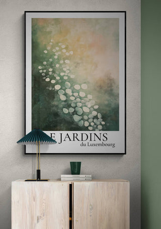 Framed Le Jardin Du Luxembourg 04 art print with abstract green and white design above a light wooden cabinet.