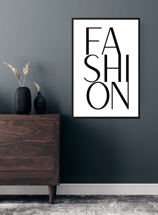 Minimalist "FASHION" poster in bold black text, styled on a dark wall above a wooden dresser with vases.