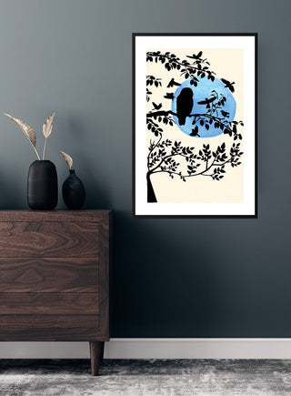 Framed Wintermorning and birds poster featuring a tree silhouette with birds against a blue circular background.