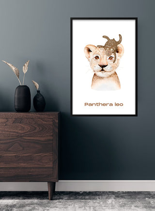 Children’s poster of a lion cub with a monkey on its head, labeled "Panthera leo," in a modern room.