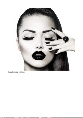 Black and white poster of a woman with bold makeup, dark lips, and the text "Beauty is an attitude."