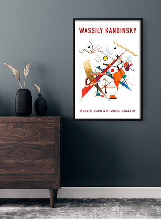 Framed Wassily Kandinsky Exhibition Plakat poster on a dark wall above a wooden dresser with modern decor.