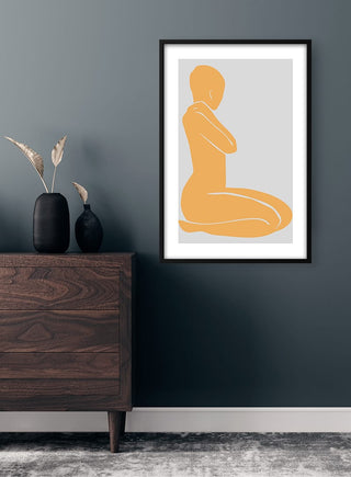 Framed Cream Yellow Woman artwork featuring a minimalist female silhouette, displayed above a modern wooden dresser.