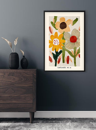Framed Flowerbomb Sunflower No. 02 Plakat with abstract sunflower art hanging on a dark wall above a dresser.