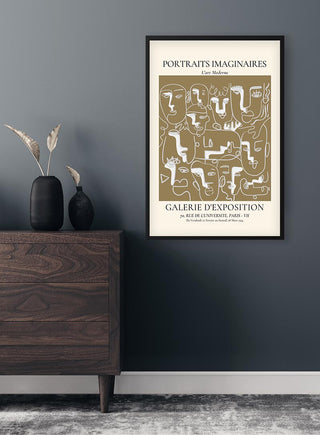 Portraits Imaginaires Brown Plakat framed on a dark wall above a wooden dresser with vases and dried plants.