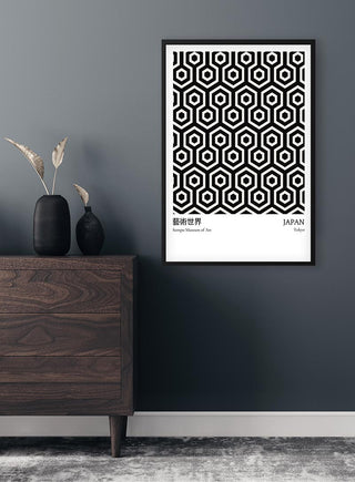 Black from Japan Exhibition Plakat featuring geometric hexagonal patterns, framed and displayed on a dark wall.