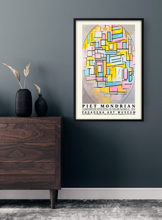 Framed Piet Mondrian Oval Composition Plakat poster on a dark wall above a wooden dresser with vases.