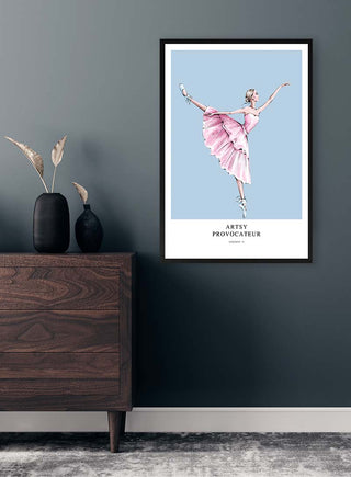 Framed "Dancing Provocateur - Vincent V." poster of a ballerina in pink, displayed above a dark wooden dresser.
