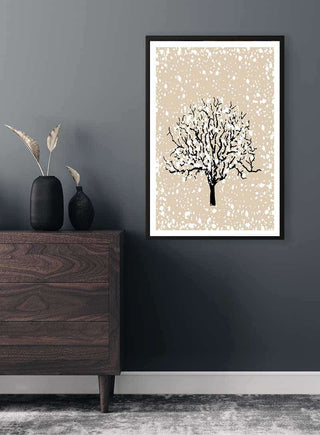 Framed Winter Tree Plakat featuring a bare tree with snow, displayed on a dark wall above a wooden dresser.
