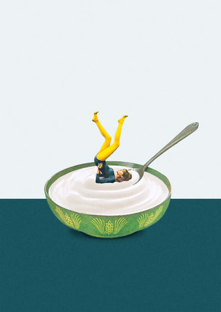 A miniature figure does a yoga pose in a bowl of yogurt with a spoon, promoting Yoga in my yogurt by Maarten Léon.